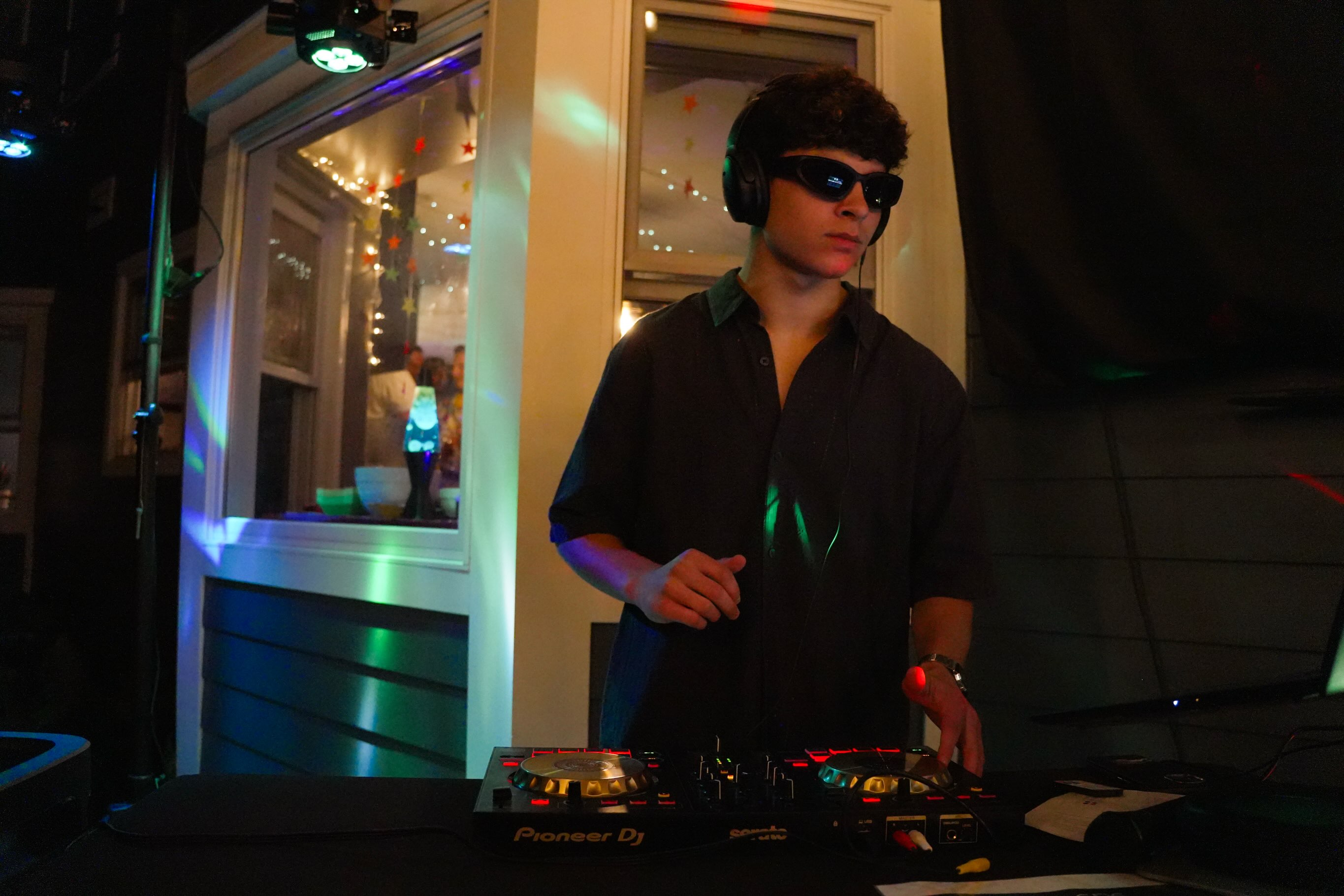 DJ Frieds mixing on Pioneer decks under green and blue party lights